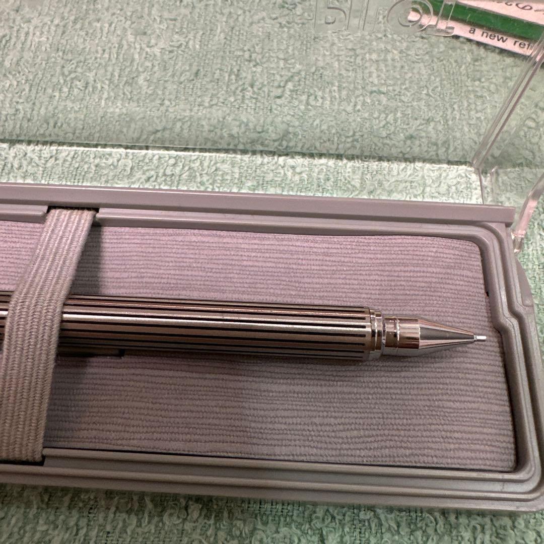 Silver Pilot Switch key-engraved pen with fine tip and stripe design beside its case