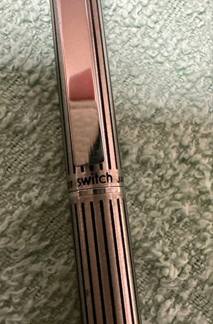 Silver Pilot Switch key-engraved pen with fine tip and stripe design beside its case