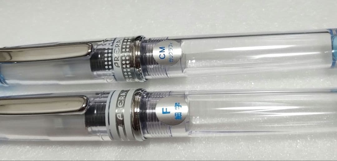 Pilot Prera fountain pen with transparent blue body and fine F nib alongside calligraphy CM nib