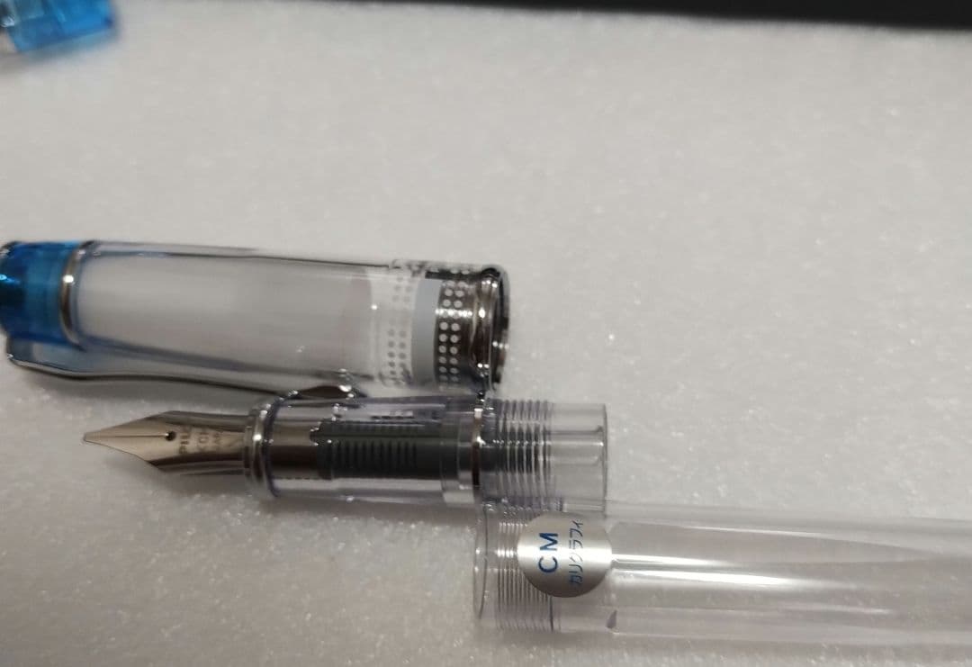 Pilot Prera fountain pen with transparent blue body and fine F nib alongside calligraphy CM nib