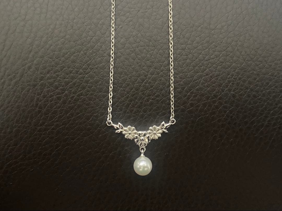 Mikimoto genuine pearl necklace with 40cm sterling silver chain on white background
