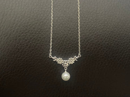 Mikimoto genuine pearl necklace with 40cm sterling silver chain on white background