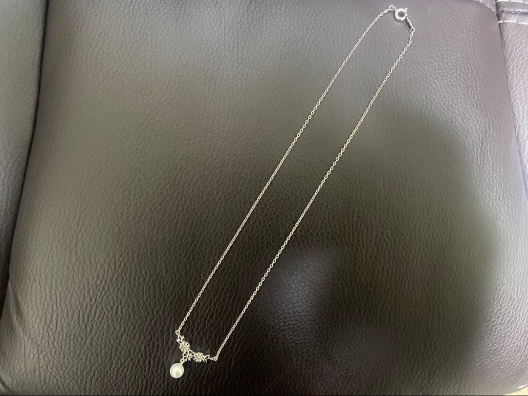 Mikimoto genuine pearl necklace with 40cm sterling silver chain on white background