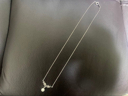 Mikimoto genuine pearl necklace with 40cm sterling silver chain on white background