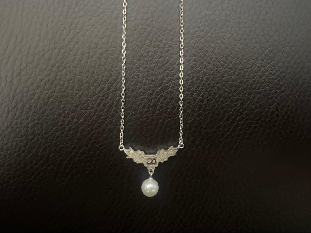 Mikimoto genuine pearl necklace with 40cm sterling silver chain on white background