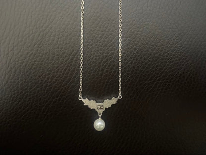 Mikimoto genuine pearl necklace with 40cm sterling silver chain on white background