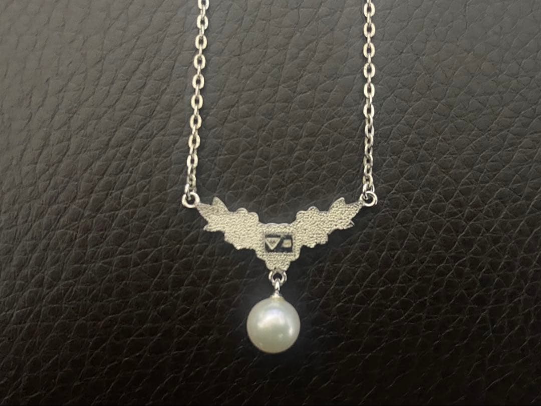 Mikimoto genuine pearl necklace with 40cm sterling silver chain on white background