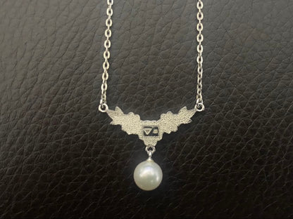 Mikimoto genuine pearl necklace with 40cm sterling silver chain on white background