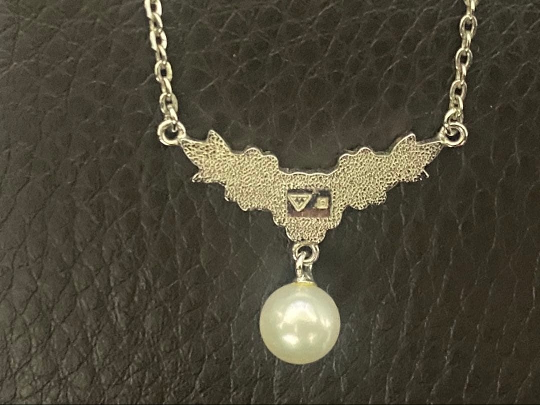 Mikimoto genuine pearl necklace with 40cm sterling silver chain on white background