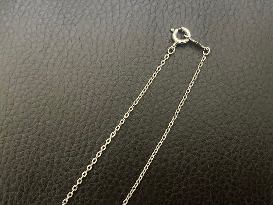 Mikimoto genuine pearl necklace with 40cm sterling silver chain on white background