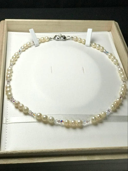 Akoya pearl and crystal necklace measuring 46.5cm with 6.6-6.9mm pearls, styled for dining events