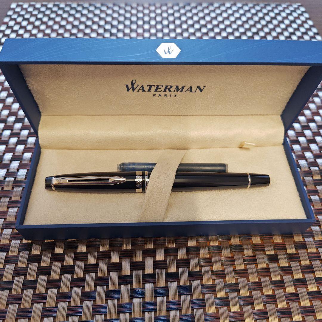 Waterman black fountain pen with blue ink cartridge and dedicated black case on white background