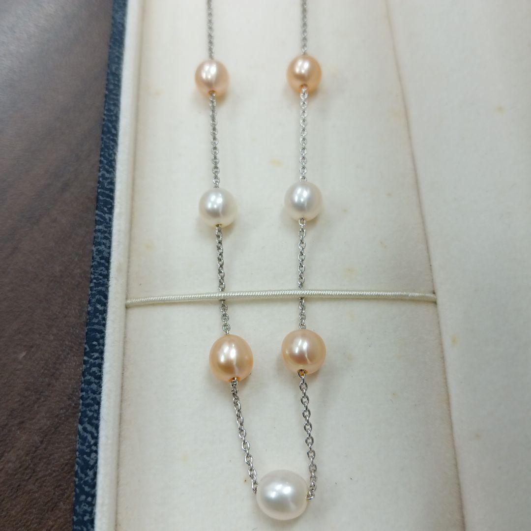 Tasaki pearl necklace made of silver with 40 cm total length displayed on a white background