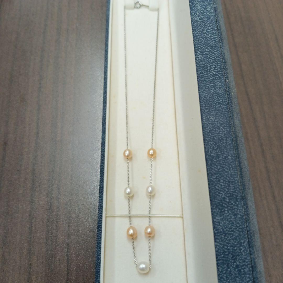 Tasaki pearl necklace made of silver with 40 cm total length displayed on a white background