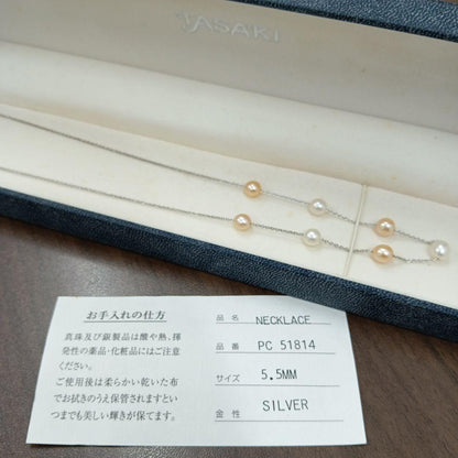 Tasaki pearl necklace made of silver with 40 cm total length displayed on a white background