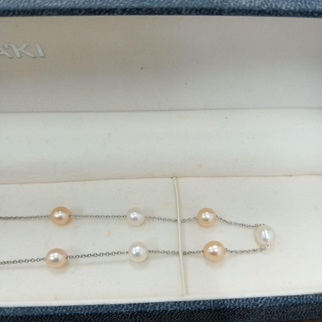 Tasaki pearl necklace made of silver with 40 cm total length displayed on a white background