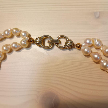 Two-row Akoya pearl necklace about 40cm long with clasp on white background