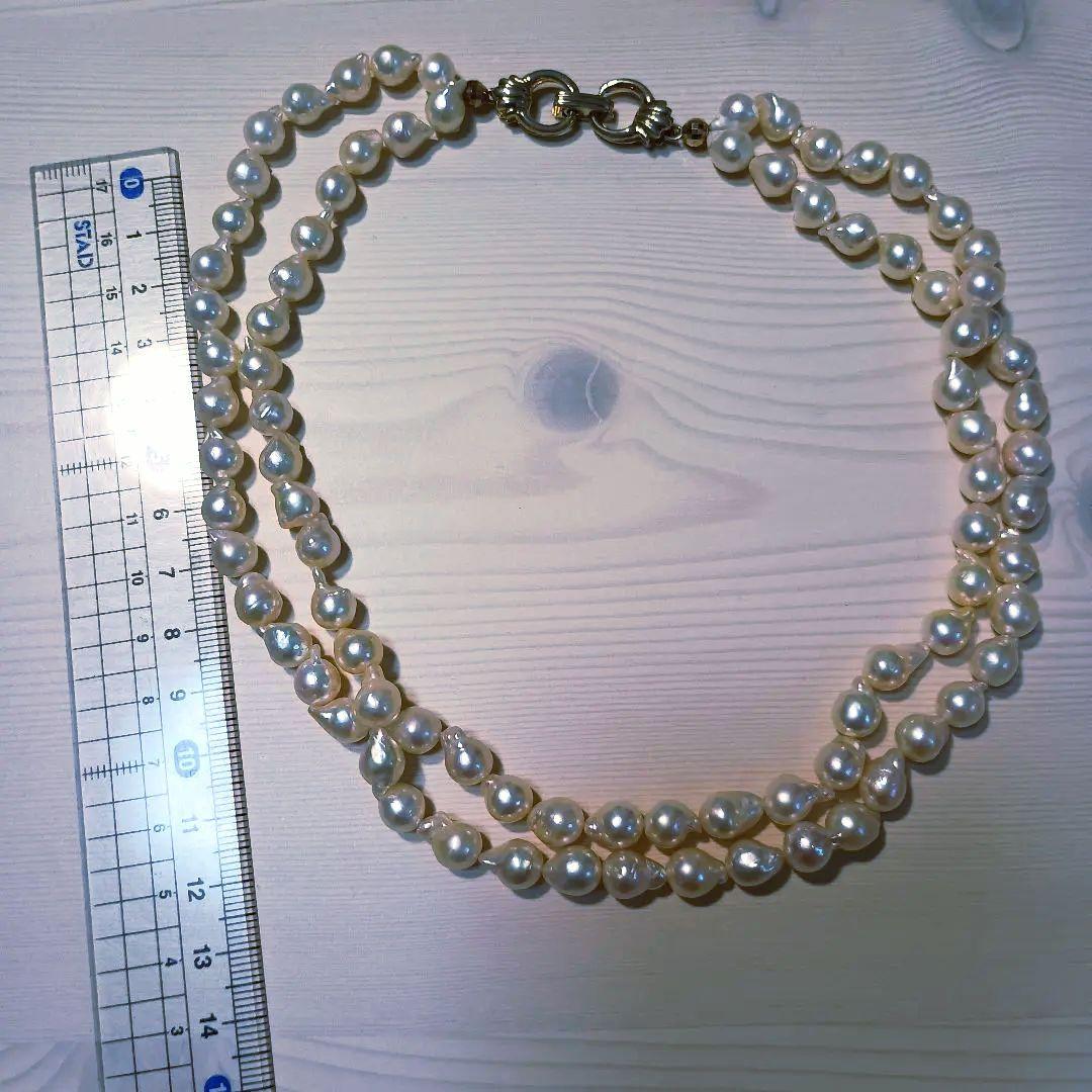 Two-row Akoya pearl necklace about 40cm long with clasp on white background