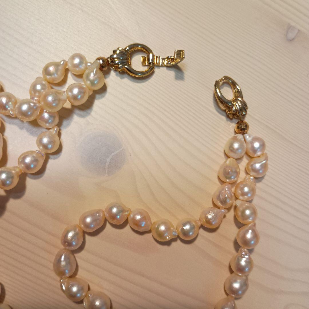 Two-row Akoya pearl necklace about 40cm long with clasp on white background