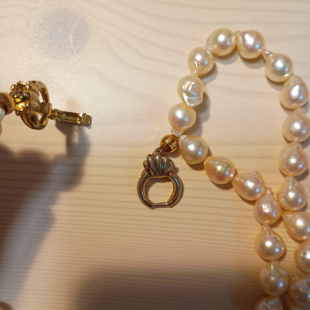 Two-row Akoya pearl necklace about 40cm long with clasp on white background