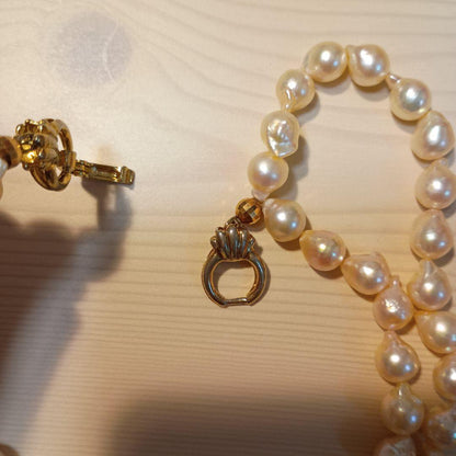 Two-row Akoya pearl necklace about 40cm long with clasp on white background