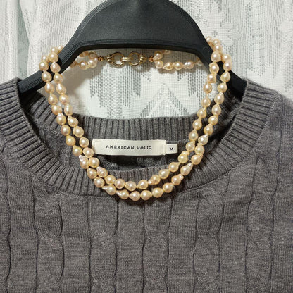 Two-row Akoya pearl necklace about 40cm long with clasp on white background