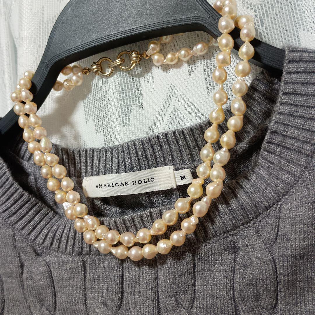 Two-row Akoya pearl necklace about 40cm long with clasp on white background