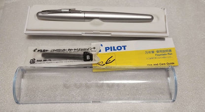 Pilot Kakuna Silver fountain pen with medium nib shown unused with packaging and black ink cartridge