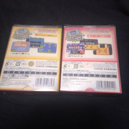 Super Mario Brothers and Kurakuri Dōchū Game Boy Advance yellow and red cartridges with games 01 and 20