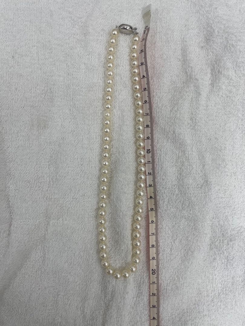 TASAKI Pearl Necklace with 6 mm pearls and 26 cm length displayed on white background