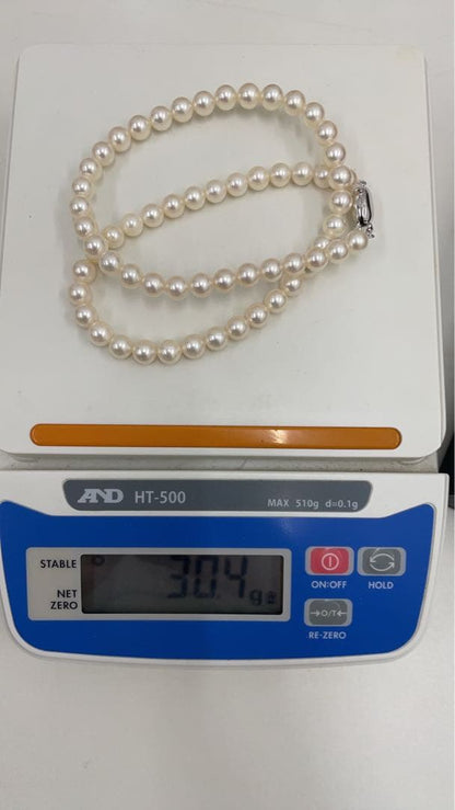 TASAKI Pearl Necklace with 6 mm pearls and 26 cm length displayed on white background