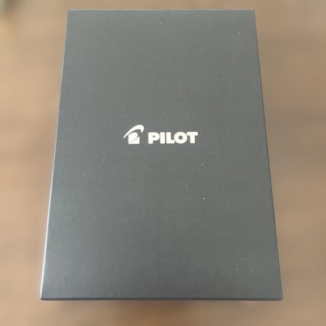 Pilot white ballpoint pen with included white case on a plain background