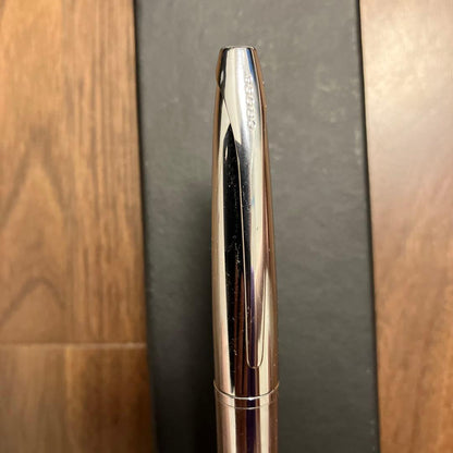 New Cross ballpoint pen with rotating tip and black ink featuring a small English cursive company name