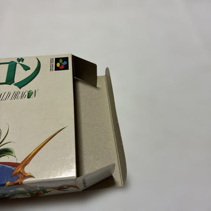 Emeraudo Doragon SNES game with original box, manual, postcard, and pamphlet displayed