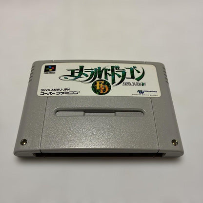 Emeraudo Doragon SNES game with original box, manual, postcard, and pamphlet displayed