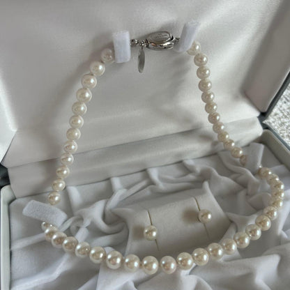 Akoya Pearl 3-piece set with necklace featuring single-pearl pendant and titanium earrings displayed in a gray case