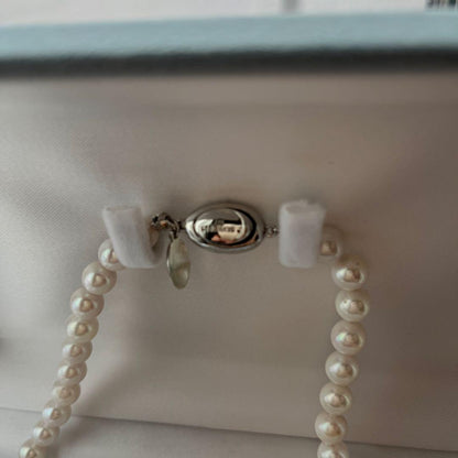 Akoya Pearl 3-piece set with necklace featuring single-pearl pendant and titanium earrings displayed in a gray case