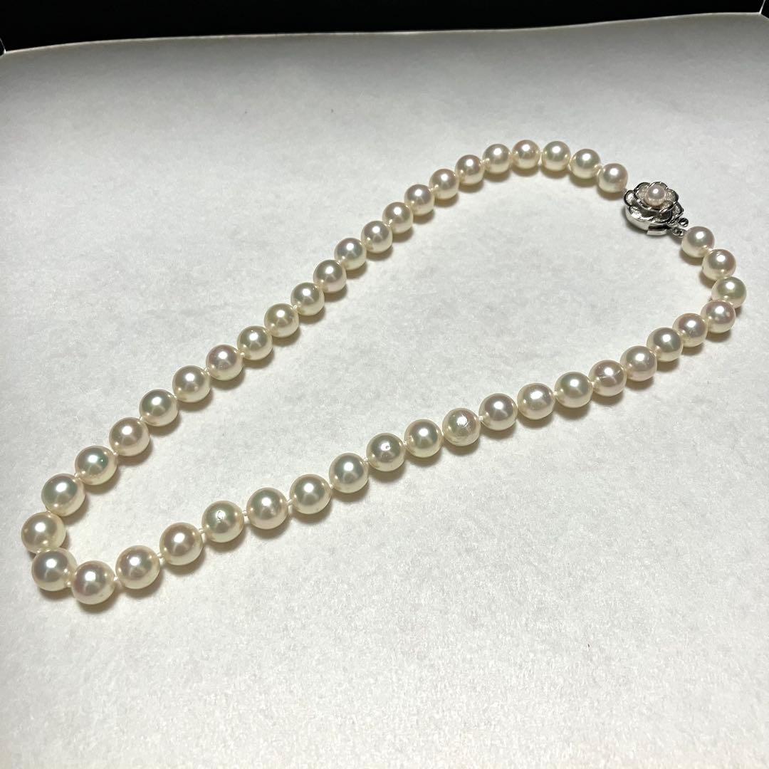Large Akoya pearl necklace with 8.5-9.0mm pearls and rose motif clasp on a white background