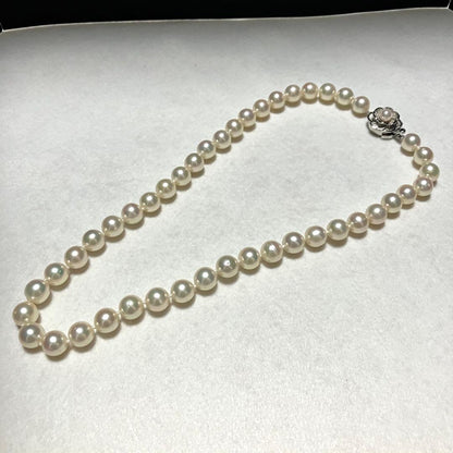 Large Akoya pearl necklace with 8.5-9.0mm pearls and rose motif clasp on a white background