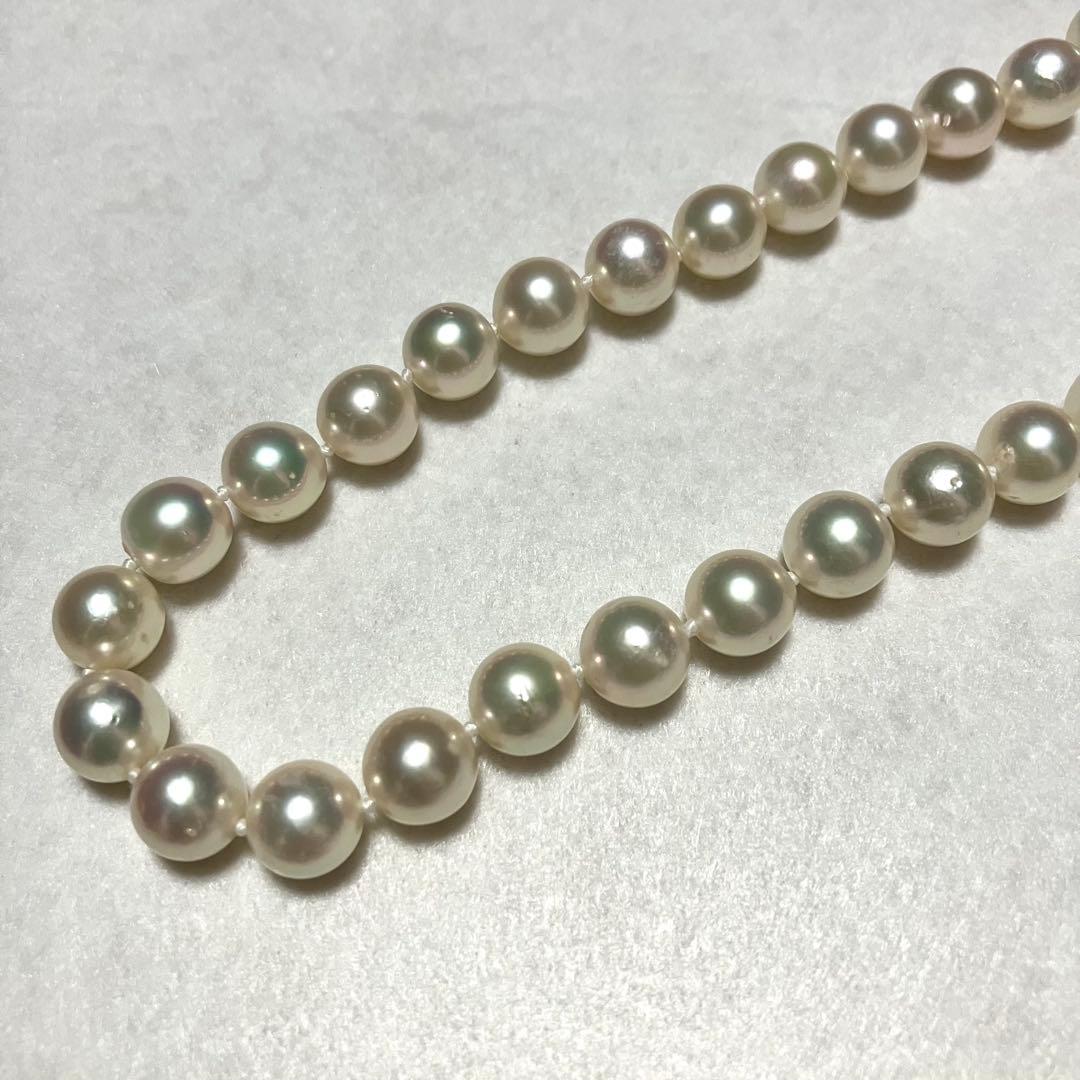 Large Akoya pearl necklace with 8.5-9.0mm pearls and rose motif clasp on a white background