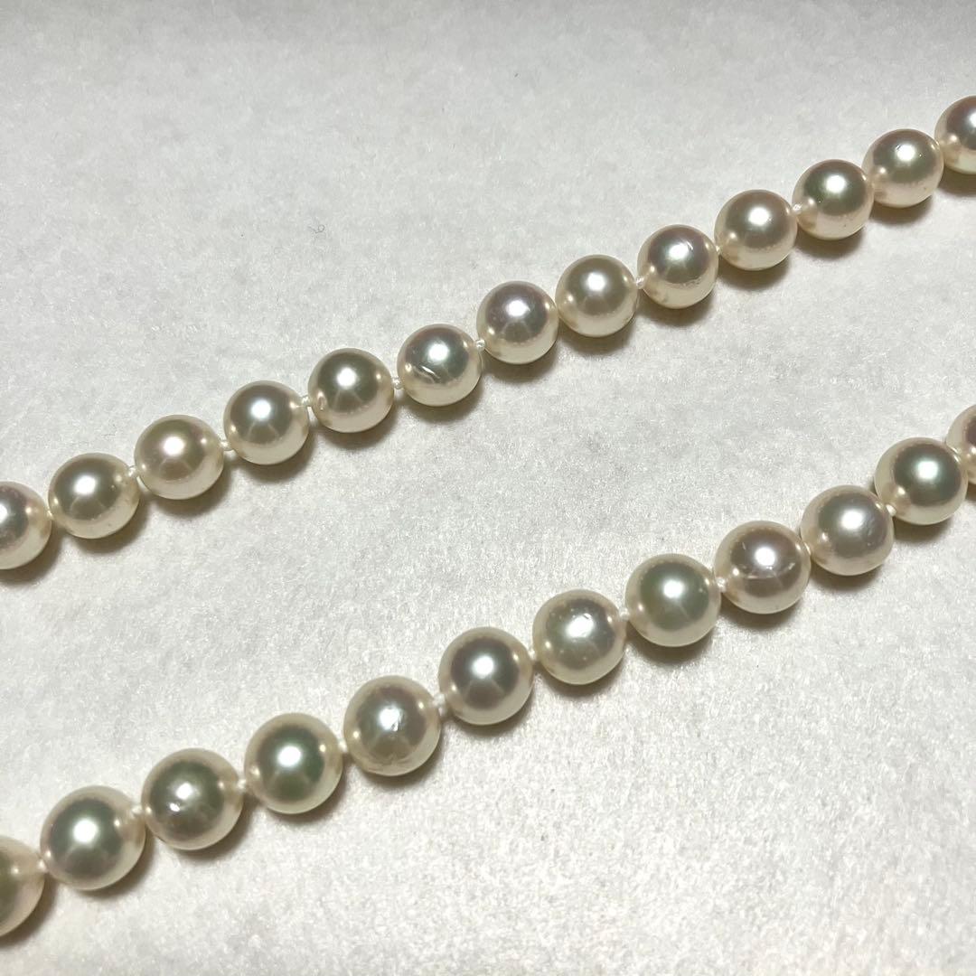 Large Akoya pearl necklace with 8.5-9.0mm pearls and rose motif clasp on a white background