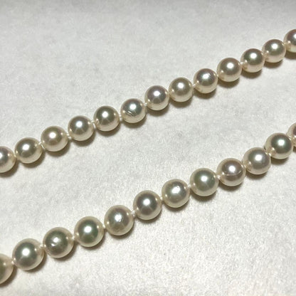 Large Akoya pearl necklace with 8.5-9.0mm pearls and rose motif clasp on a white background