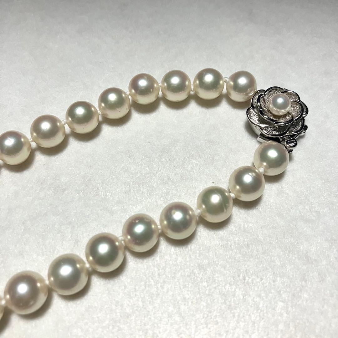 Large Akoya pearl necklace with 8.5-9.0mm pearls and rose motif clasp on a white background