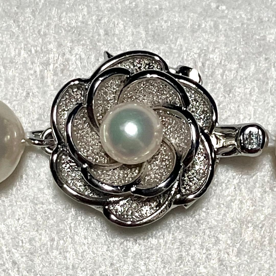 Large Akoya pearl necklace with 8.5-9.0mm pearls and rose motif clasp on a white background