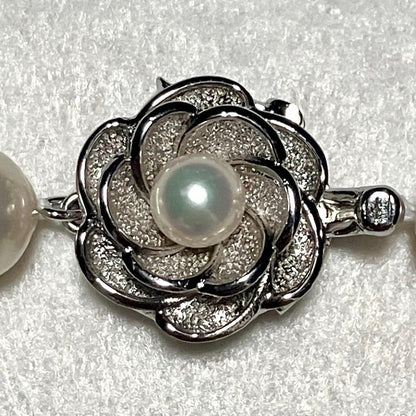 Large Akoya pearl necklace with 8.5-9.0mm pearls and rose motif clasp on a white background