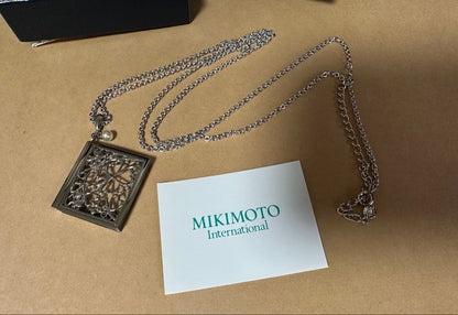 Mikimoto Loupe Pearl Chain Necklace with round pearls and fine chain alongside a small loupe accessory