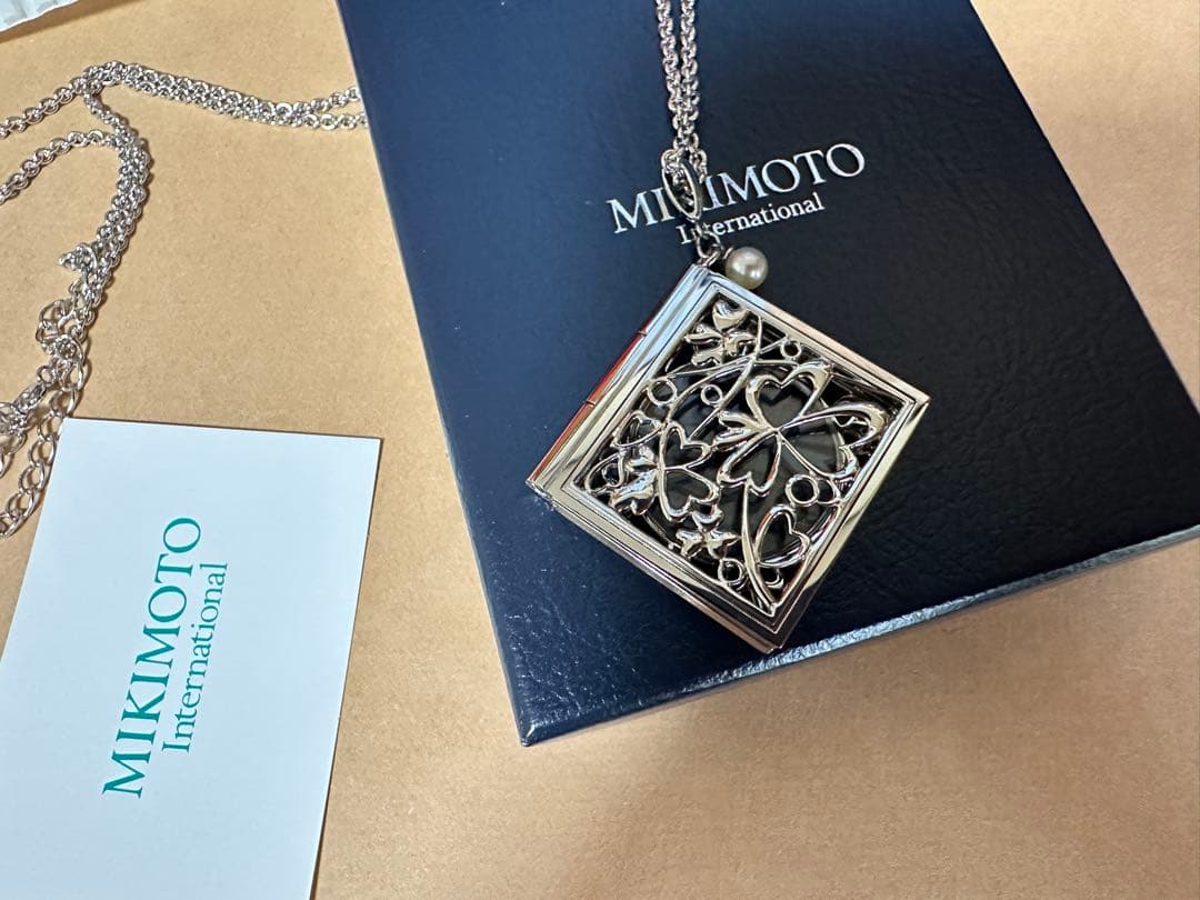 Mikimoto Loupe Pearl Chain Necklace with round pearls and fine chain alongside a small loupe accessory