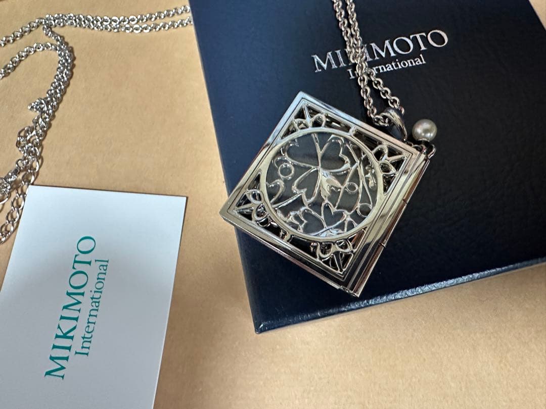 Mikimoto Loupe Pearl Chain Necklace with round pearls and fine chain alongside a small loupe accessory