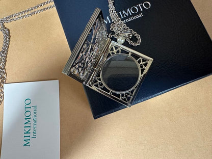 Mikimoto Loupe Pearl Chain Necklace with round pearls and fine chain alongside a small loupe accessory