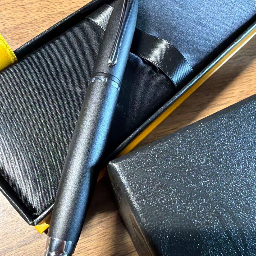 CROSS ballpoint pen in matte black finish with its dedicated protective case opened beside it